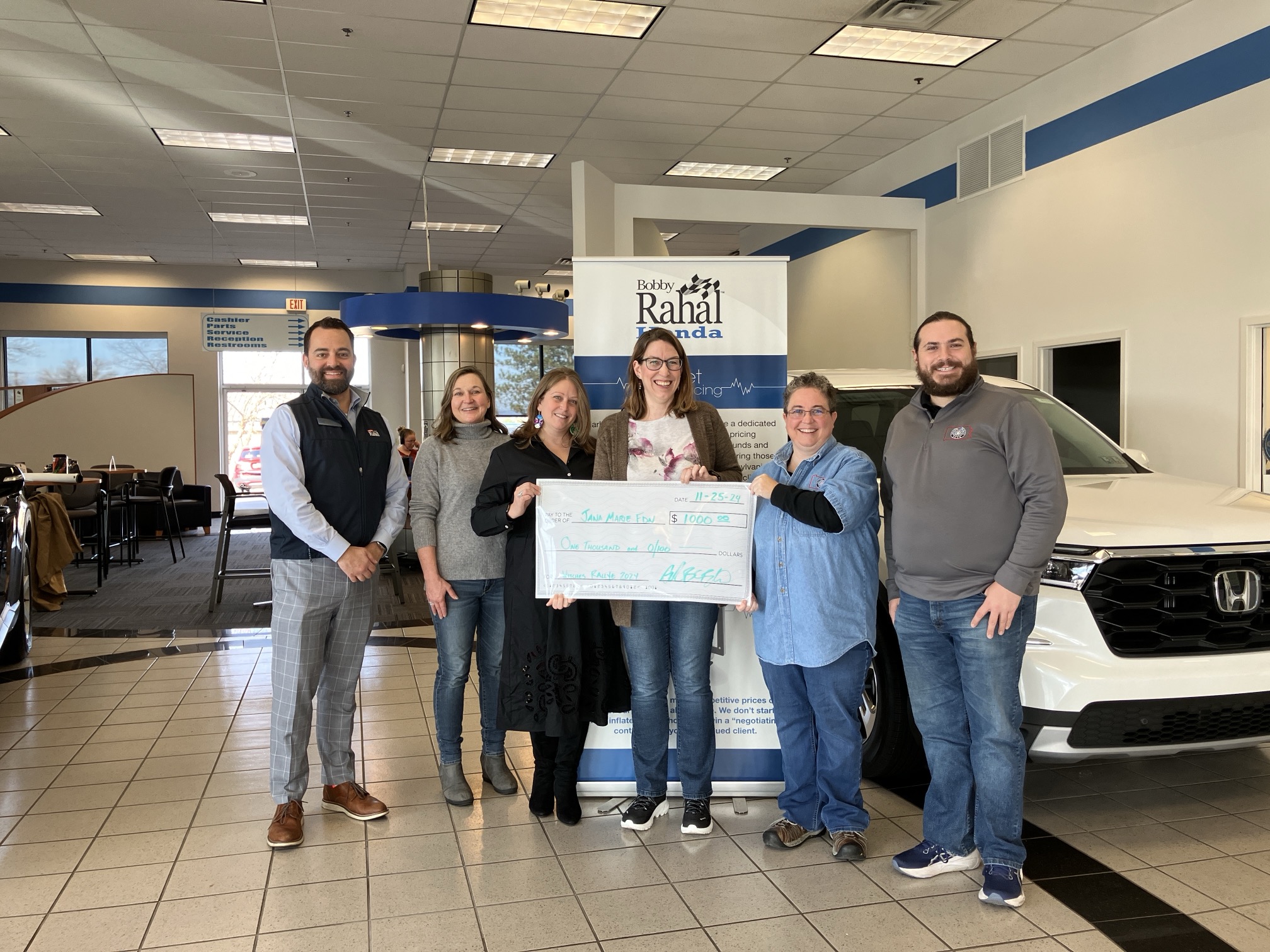 Witches Rallye Donation people holding large check